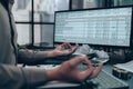 Businessman meditating in office doing yoga in lotus pose Royalty Free Stock Photo