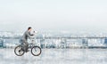 Businessman with megaphone in hand on bike