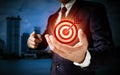 A businessman mentions In the center of a circular target, a red dart is placed. Communicate the target's company success
