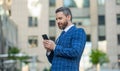 businessman messaging on phone in the street. businessman messaging on phone