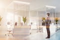 Businessman in modern white office with bookcases Royalty Free Stock Photo