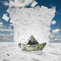 Businessman in money boat under wave of documents