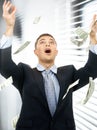 Businessman in money rain indoors Royalty Free Stock Photo