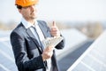 Businessman with money on a solar power plant