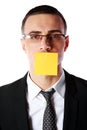 Businessman with mouth covered