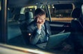 Businessman in moving car working on his laptop Royalty Free Stock Photo