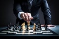 Businessman moving chess piece on chess board game