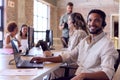 Businessman In Multi-Cultural Business Team Wearing Headsets In Customer Support Centre Royalty Free Stock Photo