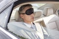 Businessman napping while wearing eye mask in car Royalty Free Stock Photo