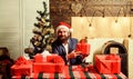 Businessman near christmas tree wrapping presents or gift boxes. Which is for me. Ready with gifts. Lets celebrate new Royalty Free Stock Photo