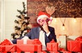 Businessman near christmas tree wrapping presents or gifts. Ready with gifts. Lets celebrate new year. For my family Royalty Free Stock Photo