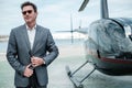 Businessman near private helicopter