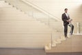 Businessman With Newspaper Standing On Steps Royalty Free Stock Photo