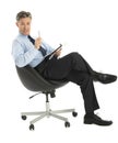 Businessman With Note Pad And Pen Sitting On Office Chair Royalty Free Stock Photo