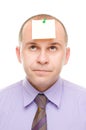 Businessman with a note pinned on his head