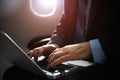 Businessman with notebook sitting inside an airplane Royalty Free Stock Photo