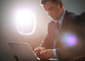 Businessman with notebook sitting inside an airplane Royalty Free Stock Photo