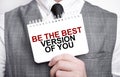 Businessman with notebook with text BE THE BEST VERSION OF YOU
