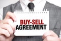 Businessman with notebook with text BUY-SELL AGREEMENT