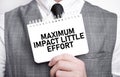 Businessman with notebook with text MAXIMUM IMPACT LITTLE EFFORT