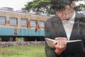 businessman with notepad hand signing documents in train repair,double exposure concept