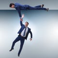 The businessman offering helping hand to falling colleague Royalty Free Stock Photo