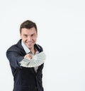 Businessman offering a wad of money in studio on a white background Royalty Free Stock Photo