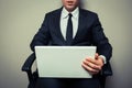 Businessman in office chair working on laptop Royalty Free Stock Photo