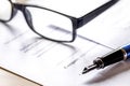 businessman office desk with contract for signig, glasses and pen Royalty Free Stock Photo