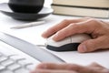 Businessman in office with hand on computer mouse Royalty Free Stock Photo