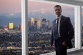 Businessman in an office looking at the view of downtown Los Angeles Royalty Free Stock Photo