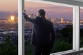 Businessman in an office looking at the view of downtown Los Angeles Royalty Free Stock Photo