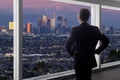 Businessman in an office looking at the view of downtown Los Angeles Royalty Free Stock Photo