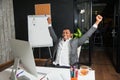 Businessman at office, success gesture, goal reached, happy man. Royalty Free Stock Photo