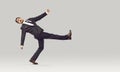 Strange funny crazy businessman in suit walking against light gray studio background Royalty Free Stock Photo