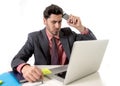 Businessman at office working stressed on computer holding mobile phone Royalty Free Stock Photo