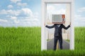 Businessman with old TV set instead of head standing in a doorway from city to the country