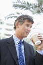 Businessman outdoors drinking coffee Royalty Free Stock Photo