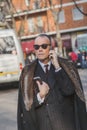 Businessman outside Armani fashion show building for Milan Men's Fashion Week 2015