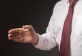 Businessman outsretched his hand for handshake over black background. Cropped man in white shirt and tie, close up Royalty Free Stock Photo