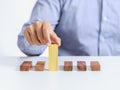 Businessman and outstanding wooden toy block