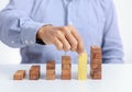 Businessman and outstanding wooden toy block