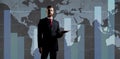 Businessman over dark background. World map background. Business, globalization, capitalism concept.