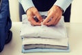 Businessman packing clothes into travel bag