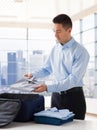 Businessman packing clothes into travel bag Royalty Free Stock Photo