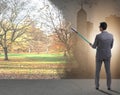 Businessman painting nature picture with roller brush