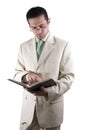 Businessman with a pair of glassed reading a book