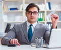 Businessman with paper airplane in office