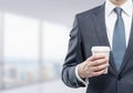 Businessman with paper coffee cup in office