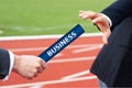 Businessman passes business relay baton to the teammate in relay race Royalty Free Stock Photo